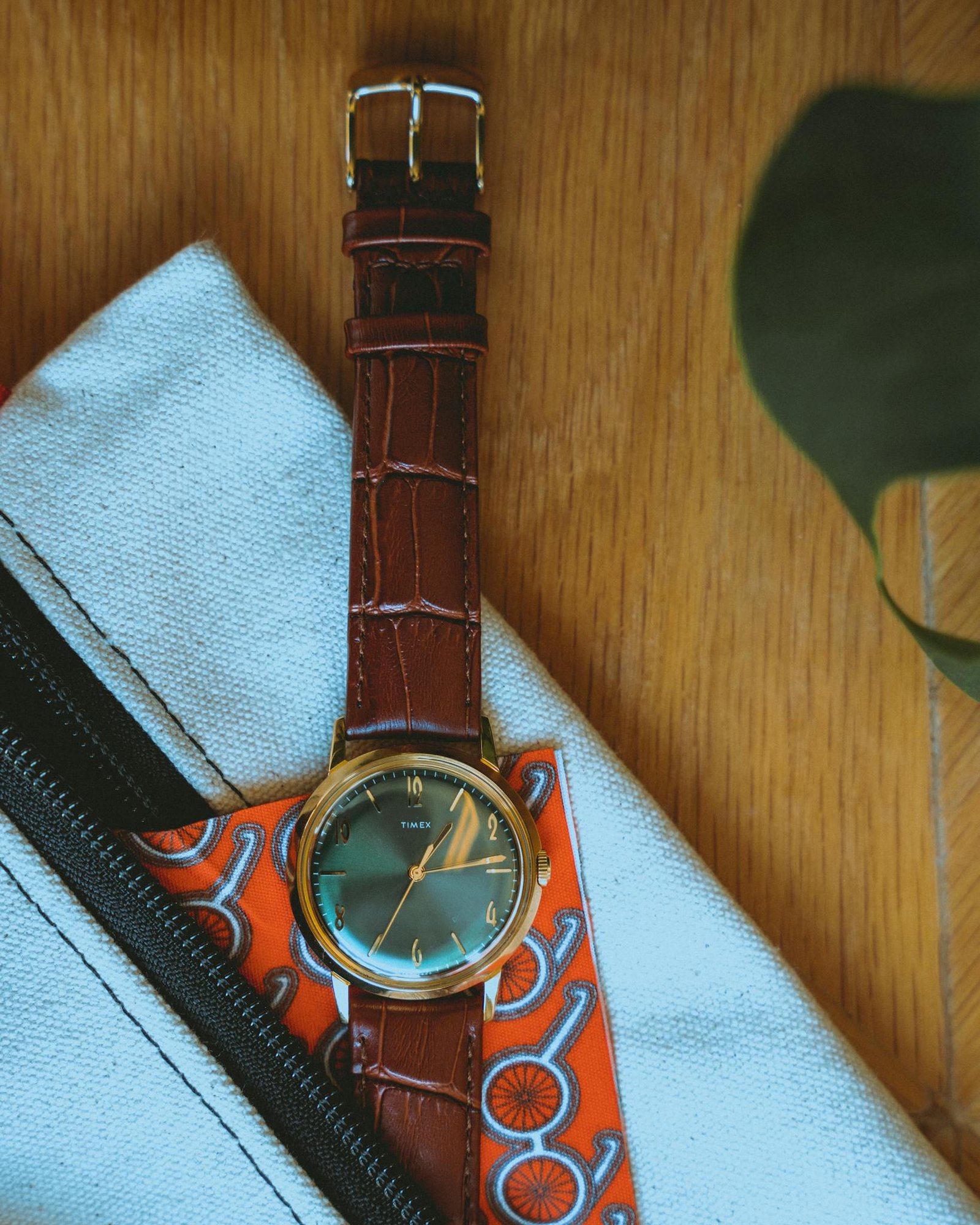 Close-up shot of a leather wristwatch on a stylish pouch, showcasing elegance and design.