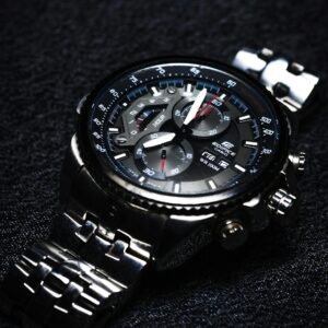 Elegant Casio chronograph wristwatch in close-up on a textured black surface.
