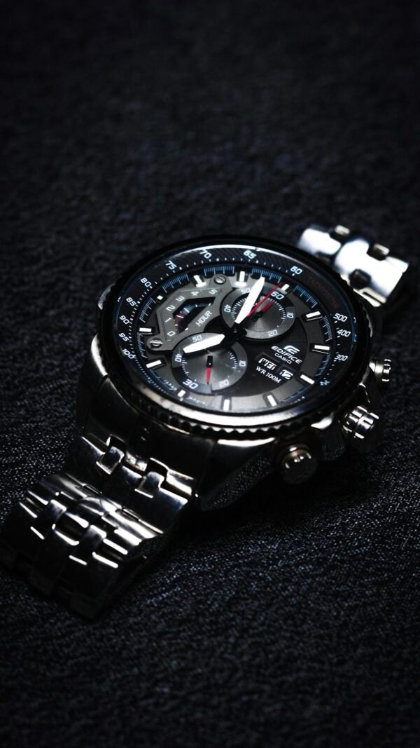 Elegant Casio chronograph wristwatch in close-up on a textured black surface.